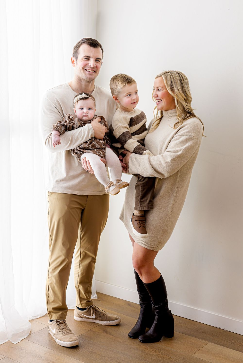 A playful sequence of photos showing a family having fun and interacting against a white wall.