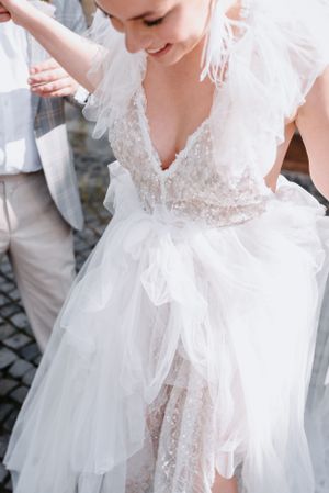 Close-up detail of delicate lace wedding dress with tulle layers.