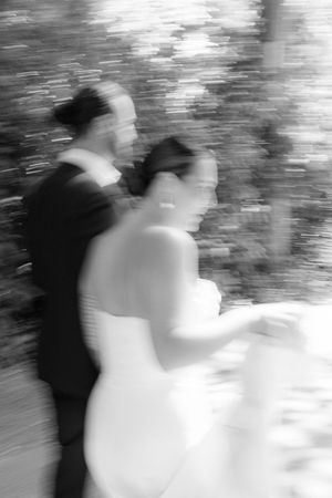 Artistic black and white blurred motion photo sequence captures a dreamy wedding dance between two figures.