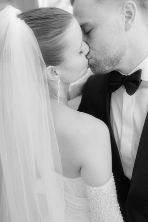 A series of black and white romantic wedding photos showing tender moments between a bride and groom.