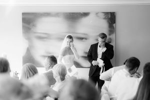 Wedding guests dance and celebrate during an energetic reception party at an indoor venue.