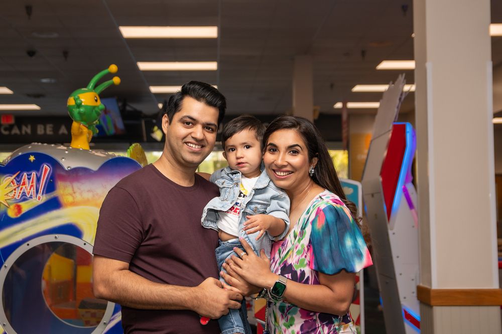 Family moment captured in indoor play area with colorful decorations.