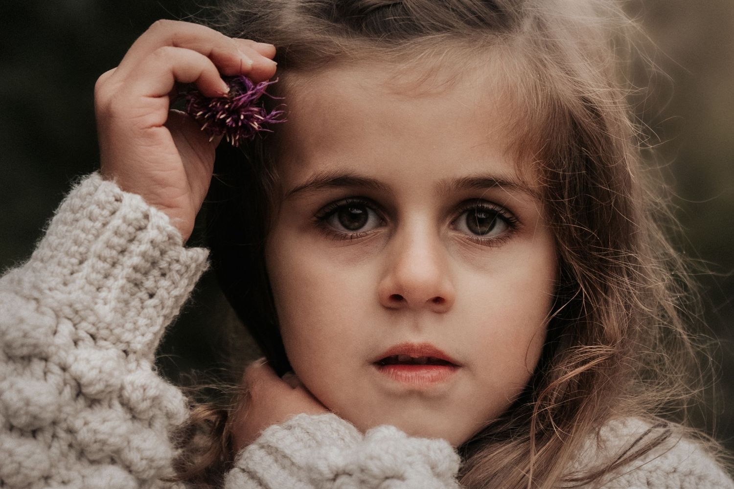 Close-up portrait in cozy knit sweater with soft natural lighting.