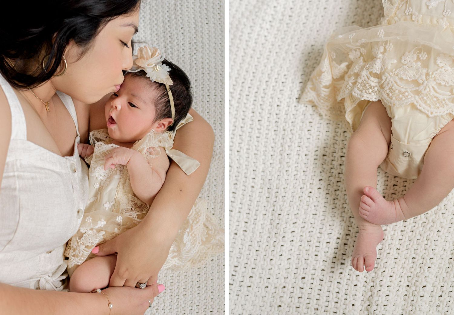 Mother cradling baby in white lace dress on textured blanket.