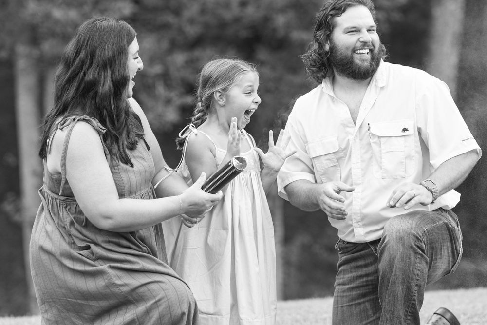 Black and white candid family photos showing joyful moments outdoors.