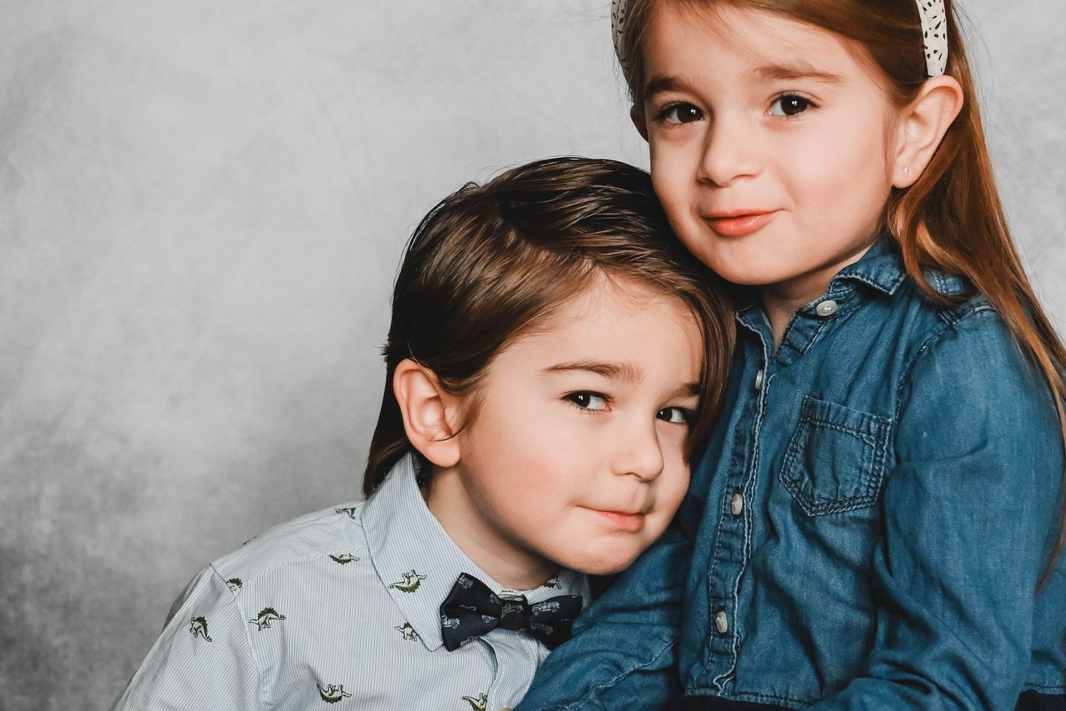 Brother and Sister looking at camera during Fine Art school photo session with K. Manchuck Photography in Hudson, NY