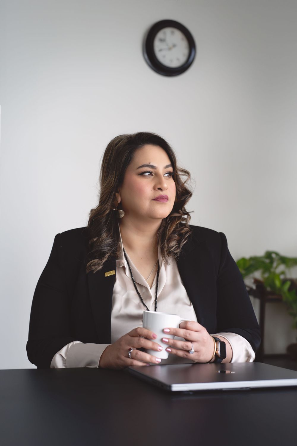 Business portraits at desk with coffee cup in professional office setting.