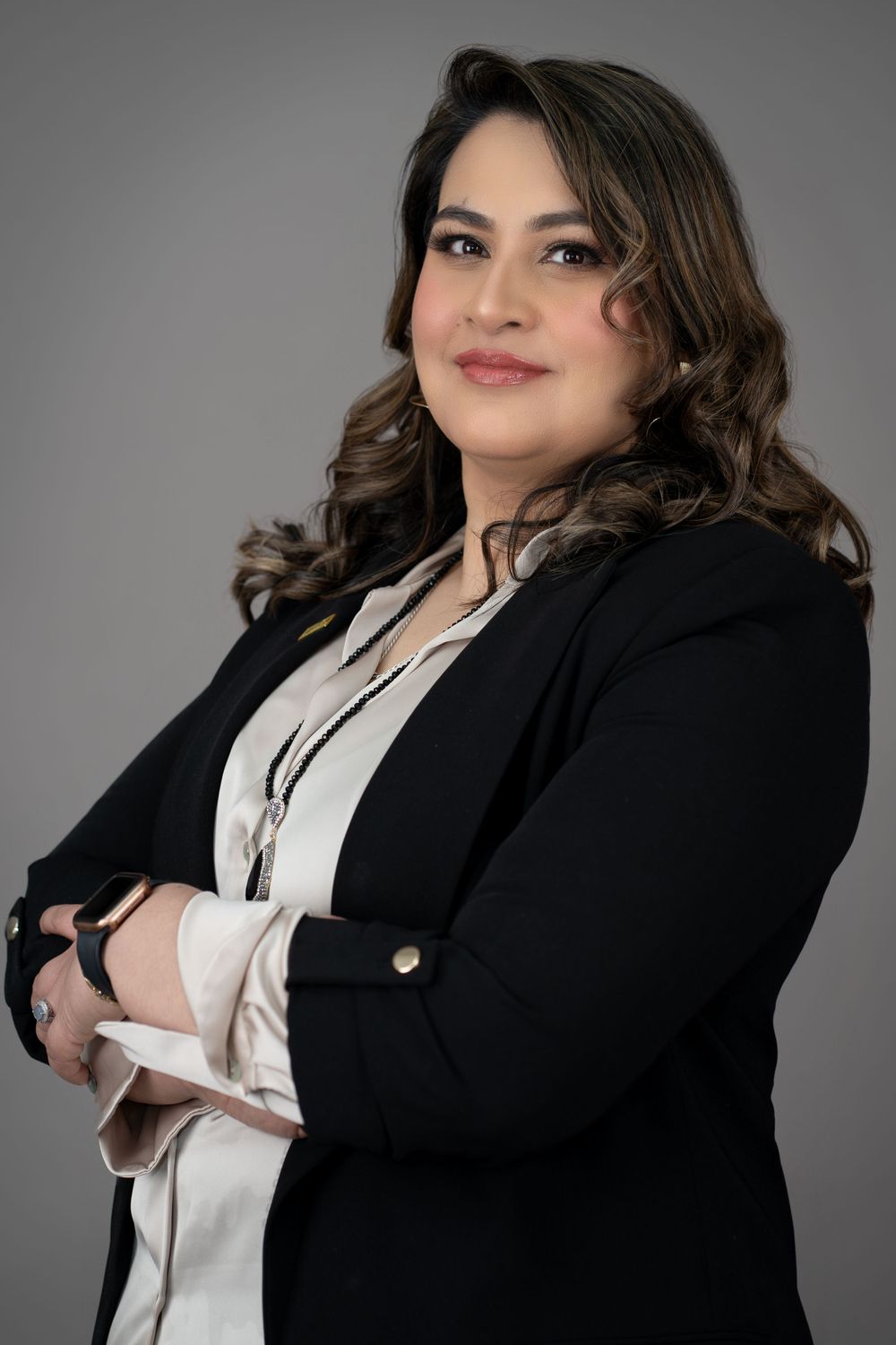 Professional portraits in black blazer and white blouse with confident poses.