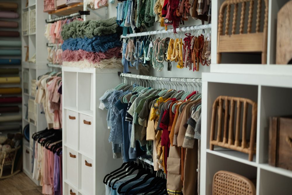 Rows of clothing arranged by color and white storage units for baby and children's apparel. Wabash Indiana