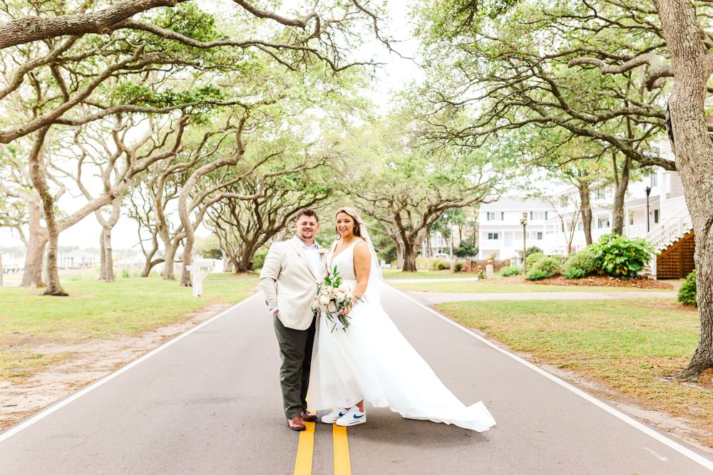 Wedding couple walking hand in hand down a tree-lined path. PRESLEY ROSE PHOTOGRAPHY OCEAN ISLE BEACH SUNSET BEACH BRUNSWICK BEACH OKI