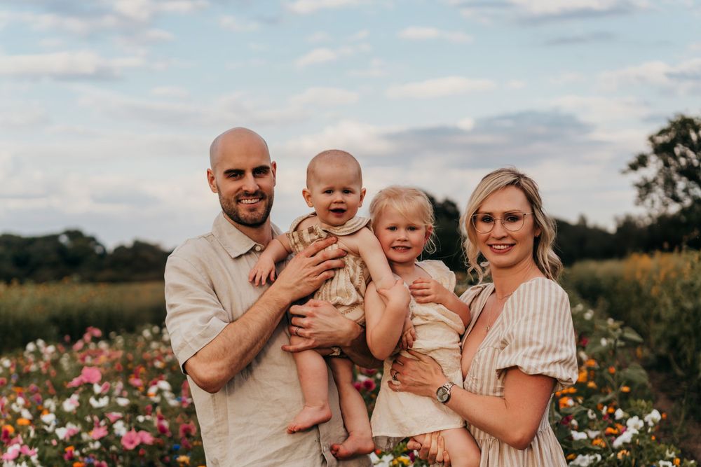 Group portrait in a flower field with wildflowers at sunset in warm golden light.  Family Photoshoot. Writtle Sunflowers.
