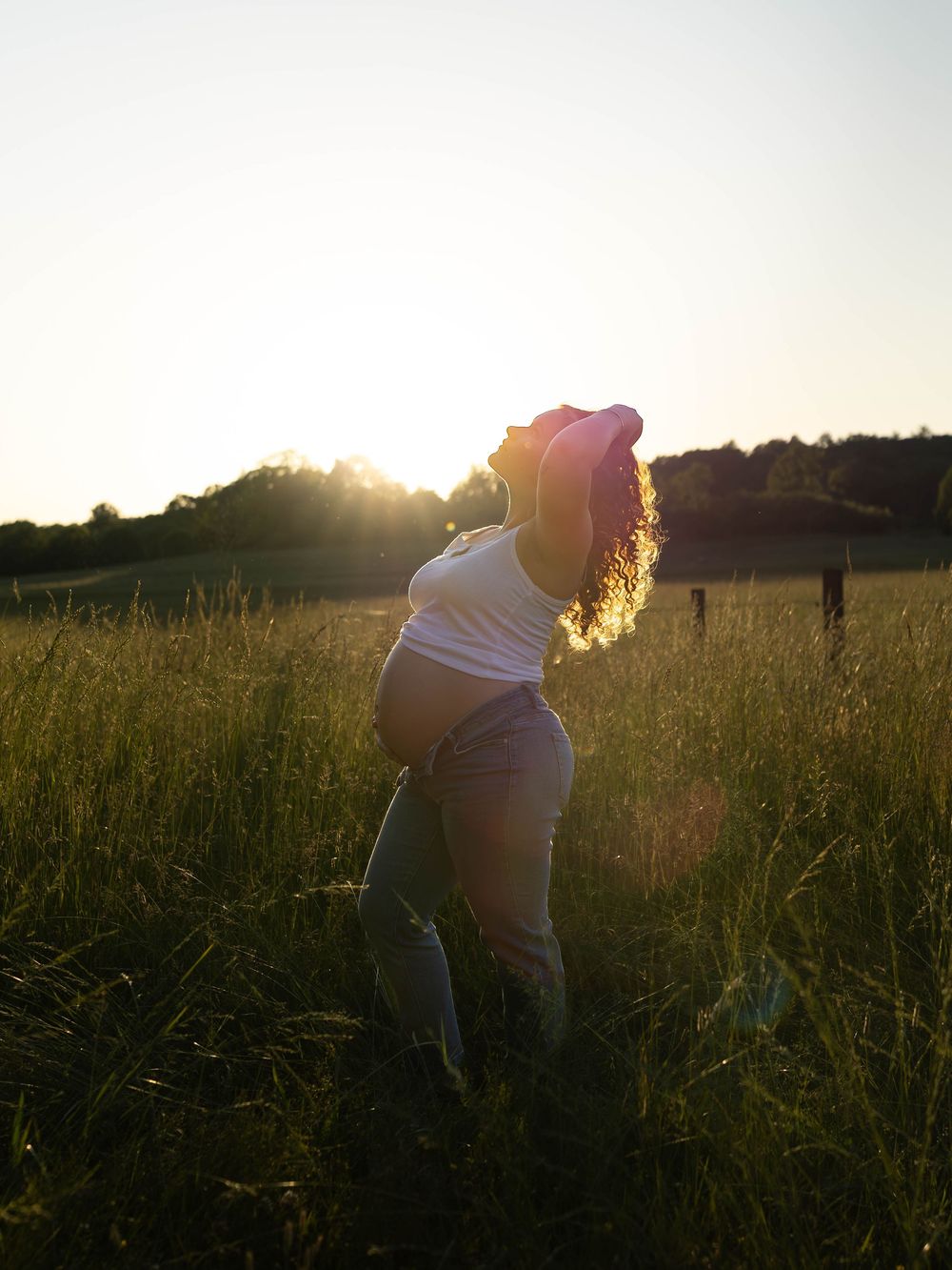 Silhouettes in a golden field during sunset creating romantic atmosphere.