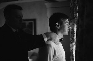 A black and white candid moment captured in an indoor setting.