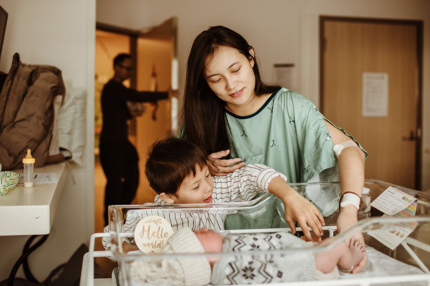 Hospital room scene with people observing medical equipment and monitoring.