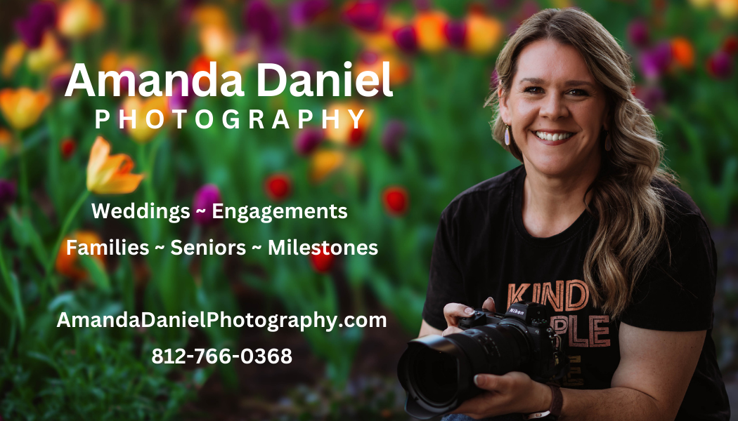 Amanda Daniel Photography business card featuring a smiling woman with a camera, offering wedding, family, and senior photography services.