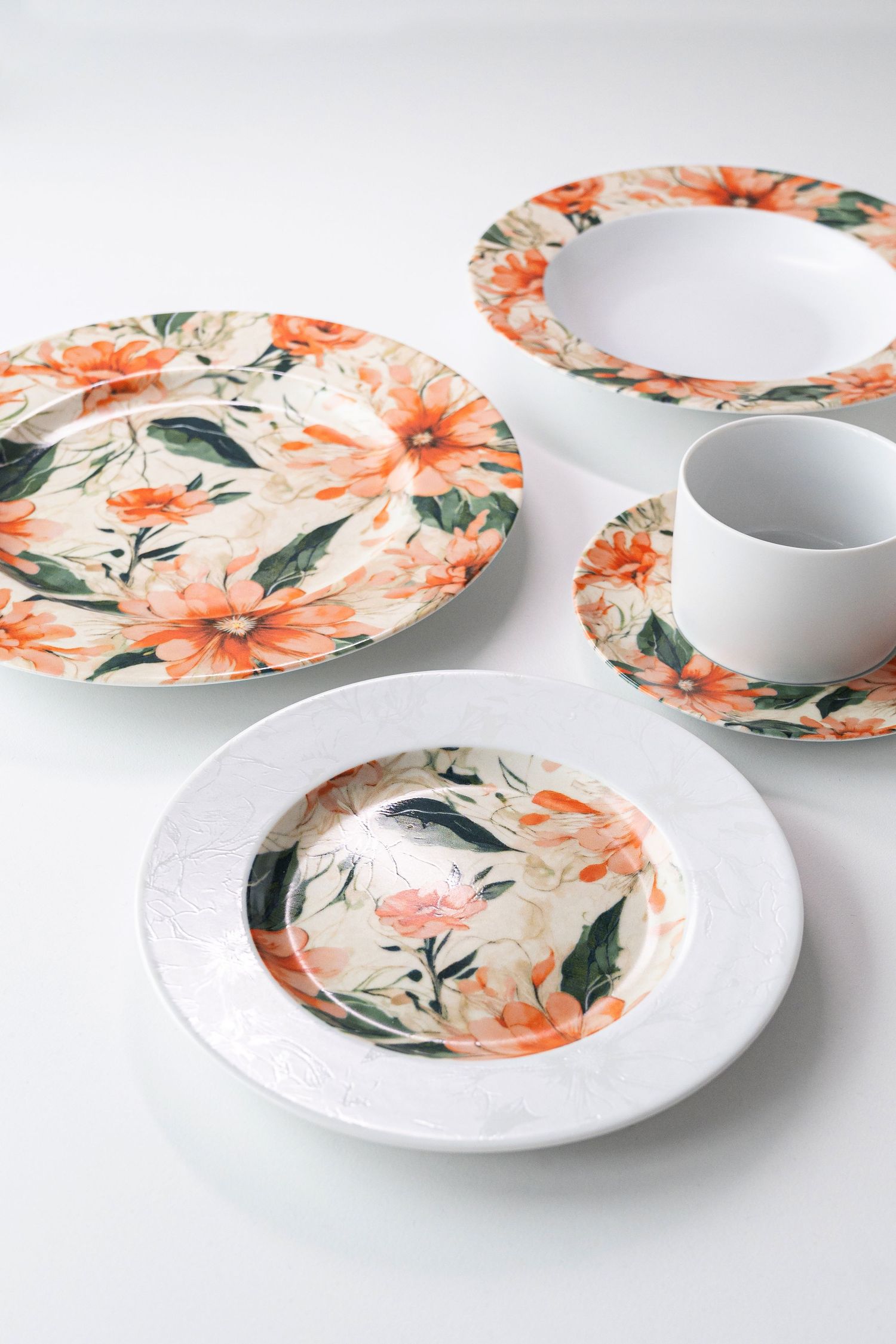 Porcelain collection Clematis with digital print, featuring vibrant orange flowers and green leaves.