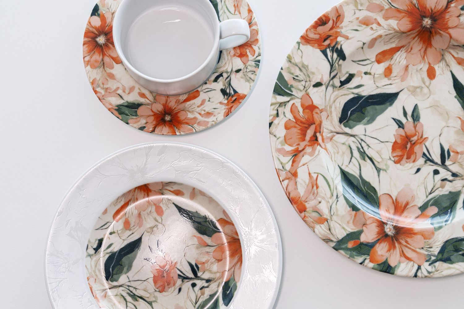 Porcelain collection Clematis with digital print, featuring vibrant orange flowers and green leaves.