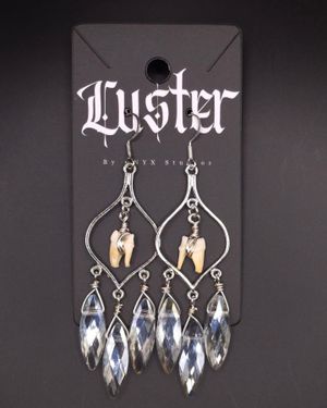 Ornate silver chandelier earrings with crystal drops and bone accents on gothic display card.