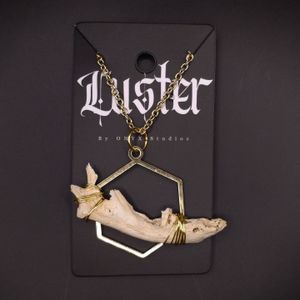 Gothic hexagonal necklace featuring a preserved bone specimen on black display card.