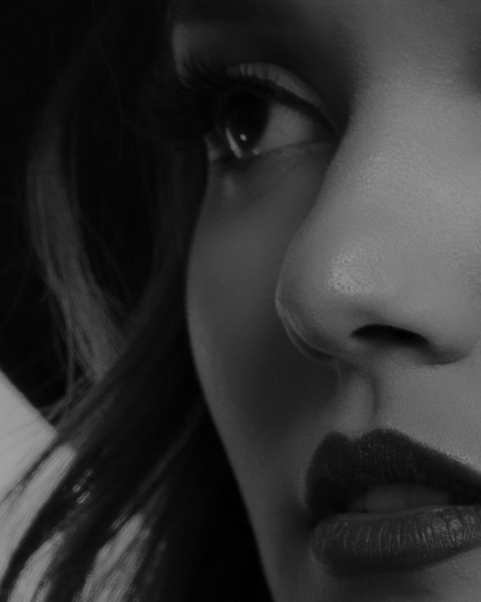 Gabriela Leal. Close-up black and white profile shot highlighting dramatic makeup and facial features.