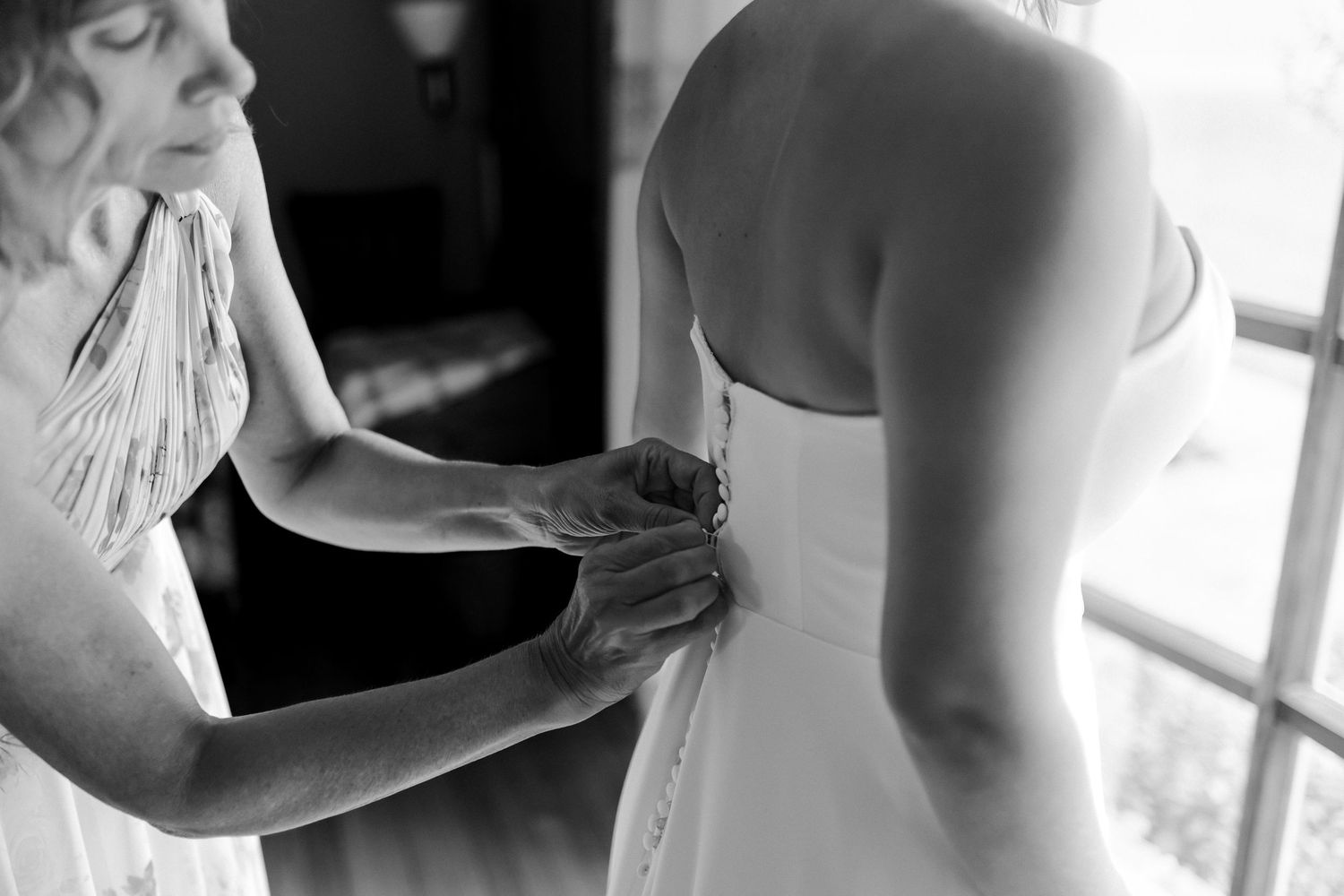 A tender moment of newlyweds holding hands while dancing at their wedding reception.
