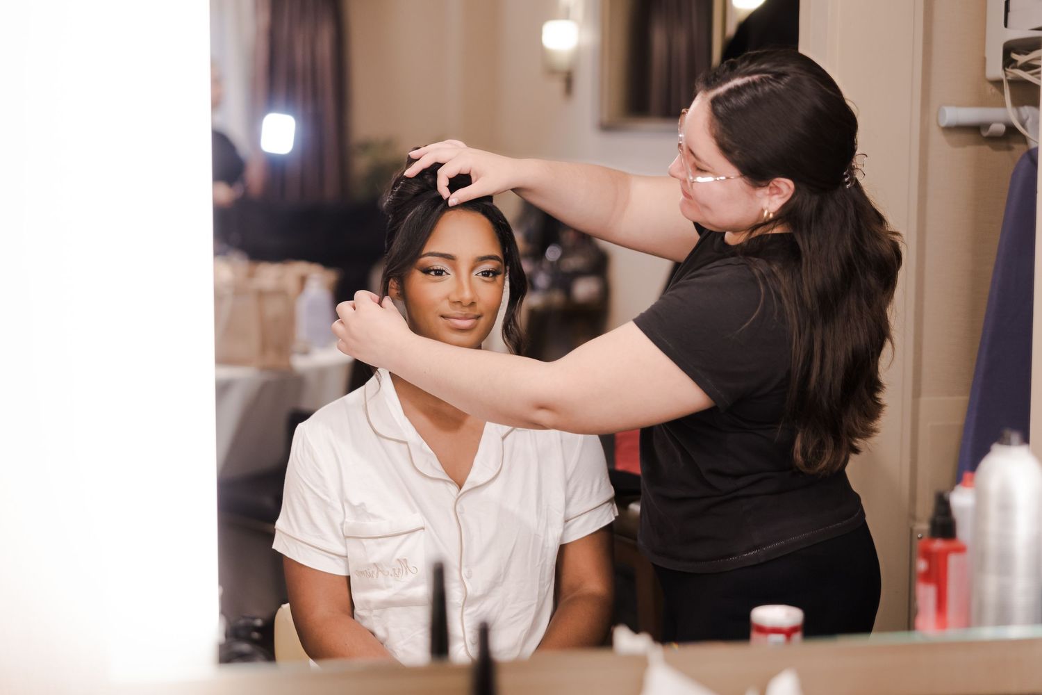 Hairstylist works on client's hair during professional salon styling session.