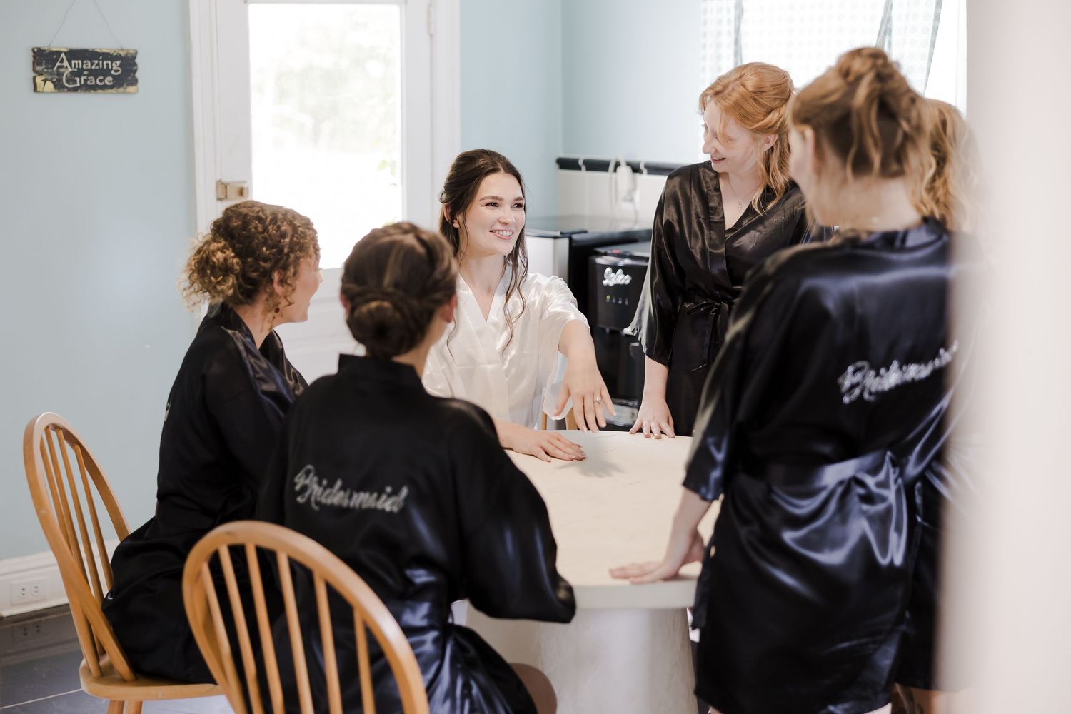 Students in black jackets work together at a table during a collaborative learning session.
