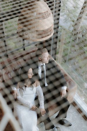 Artistic multiple exposure photo showing movement and intimacy through window blinds.