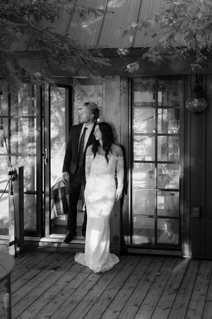 Black and white photo sequence showing a couple in formal attire by glass windows.