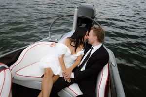 Dramatic angles capture wedding couple's intimate moments aboard a white boat.