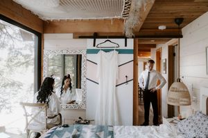 Wide angle view of a bright modern cabin interior with wooden ceiling beams.