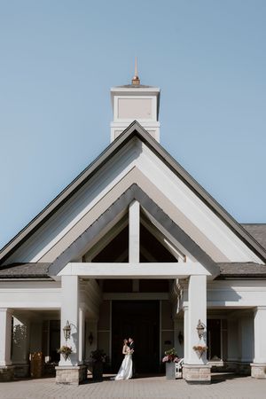 Modern white wedding venue exterior with geometric architectural details.