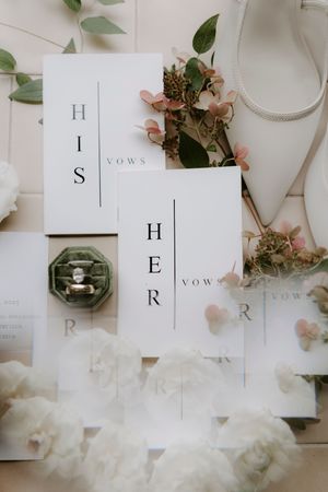 Wedding vow booklets arranged with delicate floral decorations and elegant typography.
