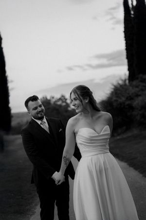 A romantic black and white wedding photo series showing a couple embracing outdoors at sunset.