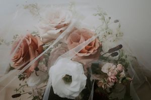 Delicate arrangement of pink and white roses with soft lighting.