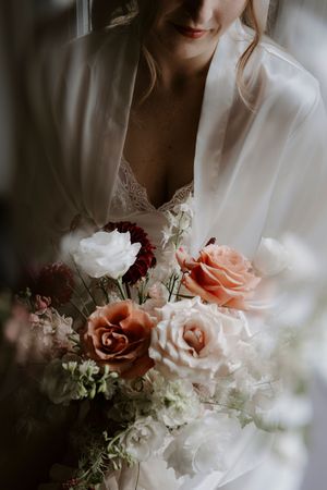Elegant bridal bouquet featuring pink and white roses with greenery.