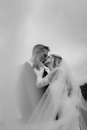 Artistic black and white close-up shots of bride and groom sharing tender moments.