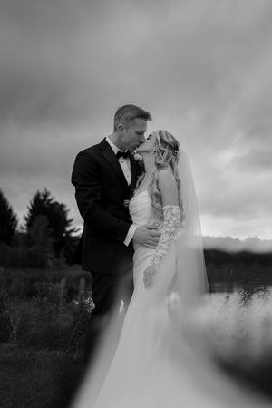 A romantic black and white wedding photo series showing a couple embracing outdoors.