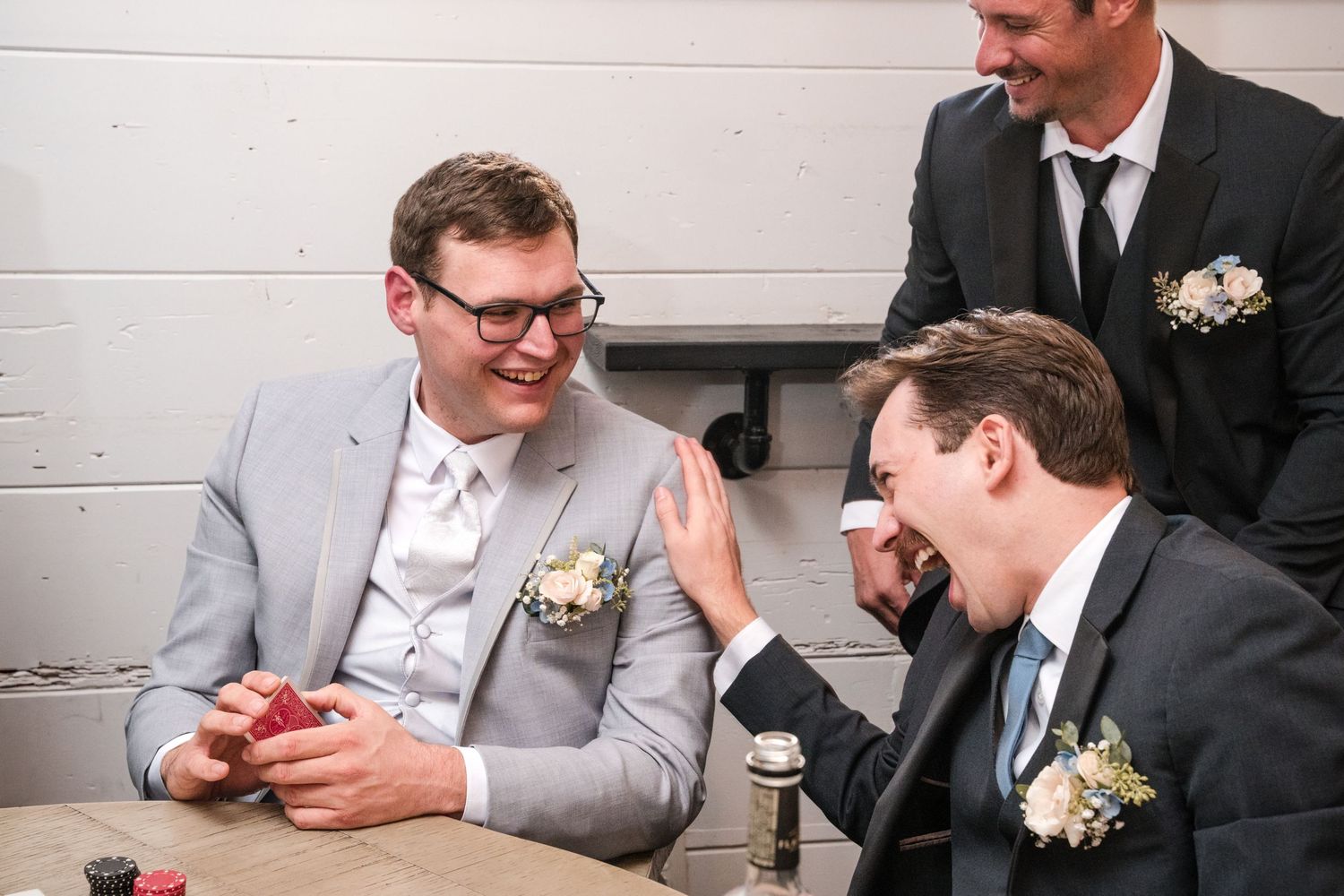 A series of candid moments at a wedding reception showing guests in formal attire interacting at tables.