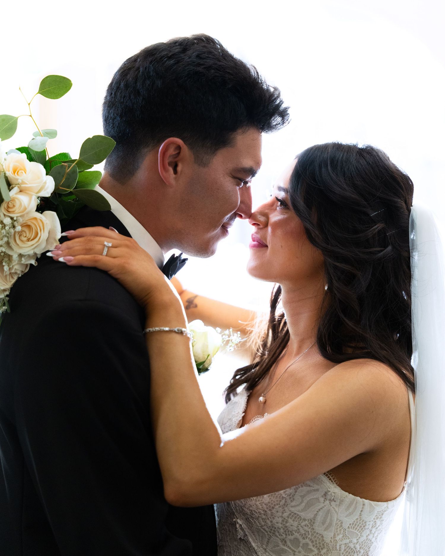 Romantic black and white photo sequence showing couple's intimate embrace during their wedding celebration.