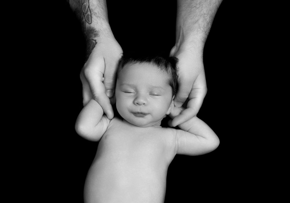 Artistic black and white portraits of a peaceful sleeping newborn baby.