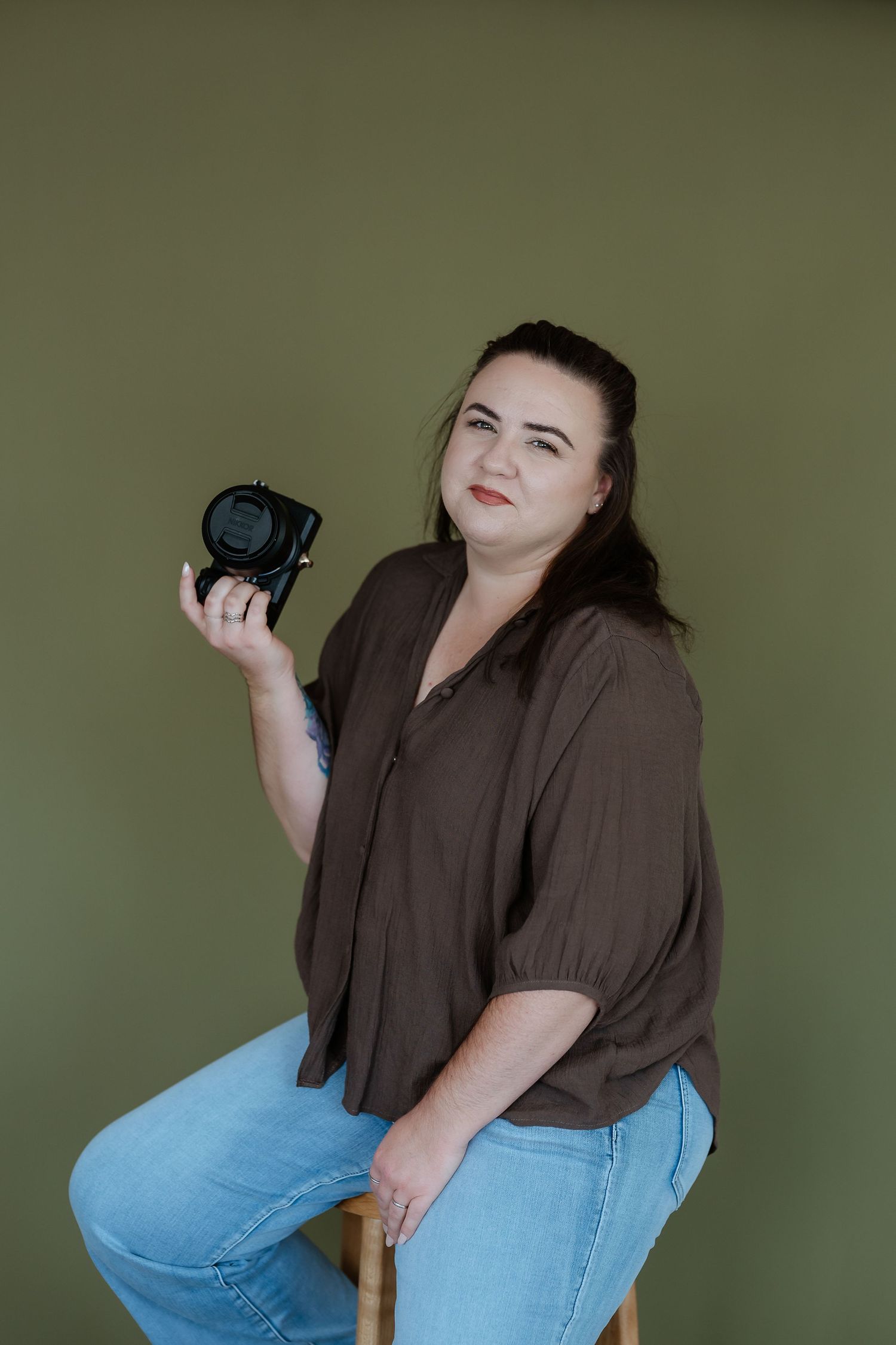 Series showing photographer with camera against olive green background in gladstone studio.
