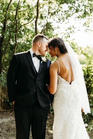 A biracial couple pose for their wedding portraits on their wedding day in Broken Arrow, Oklahoma.