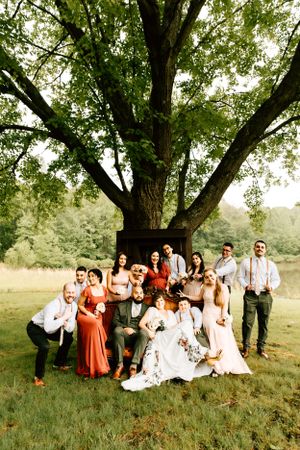 A couple pose with their wedding party on a couch on their wedding day on their family property in Warrenton, Virginia.