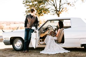A couple poses in a vintage car on their wedding day in Osage County, Oklahoma outside of Barnsdall after an EF4 tornado.