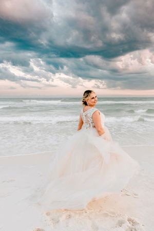 A bride poses for her bridal portraits on her beach wedding day in Destin, Florida.