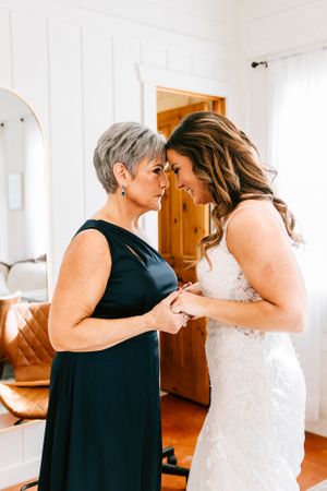 A bride has a moment with her mother on her wedding day at her wedding venue at Bridle Creek in Sperry, Oklahoma.