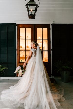 A bride poses for her bridal portraits on her beach wedding day in Destin, Florida.