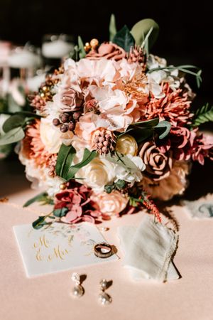 A wedding flatlay with a bouquet at the Barns at Timber Creek Bed & Breakfast in Winfield, Kansas.