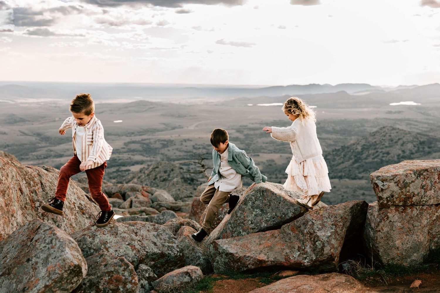 Wichita Mountain Refuge family photos with two kids playing on rocks.